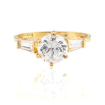 Gold ring with a large diamond on a white background