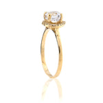 Gold ring with a clear gemstone on a white background