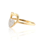 Gold ring with heart design and embedded diamonds on a white background