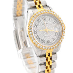 two-tone stainless steel and yellow gold Rolex Datejust luxury watch featuring a custom diamond bezel, iced out dust dial, and silver Roman numerals by SB Jewelers.