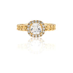 Gold ring with a diamond on a white background