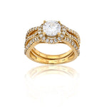 Gold ring with a large central diamond and smaller diamonds on a white background