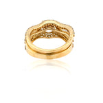 Gold ring with intricate design on a white background