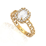 Gold ring with a large central gemstone and smaller stones on a white background