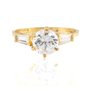 Gold ring with a large diamond on a white background