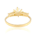 Gold ring with a unique design on a white background