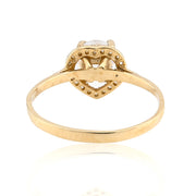 Gold ring with heart design and small diamonds on a white background
