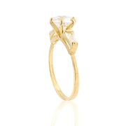 Gold ring with a clear gemstone on a white background