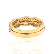 Gold ring with intricate design on a white background