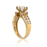 Gold ring with a diamond on a white background