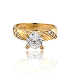 Gold ring with two large clear gemstones on a white background