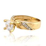 Gold ring with a diamond on a white background