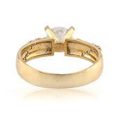 Gold ring with a central diamond on a white background