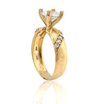 Gold ring with diamond accents on a white background