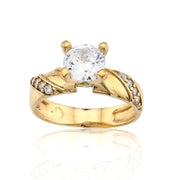 Gold ring with a large central diamond and smaller diamonds on the band against a white background