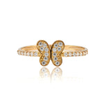 Gold butterfly ring with diamond accents on a white background