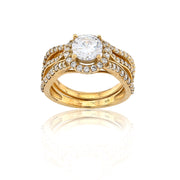 Gold ring with a large central diamond and smaller diamonds on a white background
