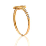 Gold ring with small diamonds on a white background