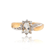 Gold ring with a central gemstone on a white background
