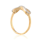Gold ring with diamond accents on a white background