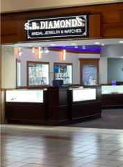 Jewelry store with 'S.B. Diamonds' sign and display cases.