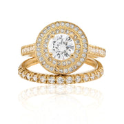 Gold ring with diamond accents on a white background