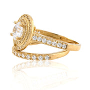 Gold ring with diamond accents on a white background