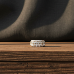 Silver ring with multiple diamonds on a wooden surface