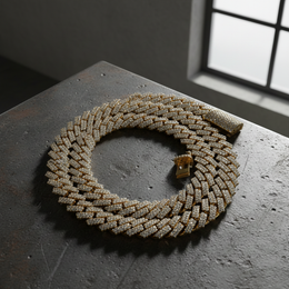 Gold braided necklace on a dark surface with a window in the background